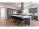 Modern kitchen with gray cabinetry, a large island, and stainless steel appliances at 90 E Leverenz Ave, Queen Creek, AZ 85140