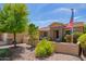 Single-story home with landscaped front yard and American flag at 20980 N Sweet Dreams Dr, Maricopa, AZ 85138