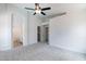 Main bedroom with ceiling fan, carpet flooring and en-suite bathroom at 16108 W Kendall St, Goodyear, AZ 85338