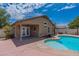 Relaxing backyard oasis featuring a refreshing pool and covered patio at 16108 W Kendall St, Goodyear, AZ 85338