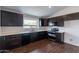 Modern kitchen with dark brown cabinets, white countertops, and stainless steel appliances at 16108 W Kendall St, Goodyear, AZ 85338