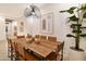 Elegant dining room with wood table and modern light fixture at 22511 E Saddle Ct, Queen Creek, AZ 85142