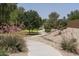 Curved walking path meandering through a landscaped park at 1720 W Coolidge Way, Coolidge, AZ 85128