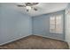 Light blue bedroom with window and ceiling fan at 17218 N Melissa Ln, Surprise, AZ 85374