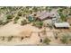 Aerial view of property with house, pool, stables and large open space at 35140 N 52Nd Pl, Cave Creek, AZ 85331