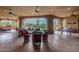 Large covered patio with multiple seating areas, offering stunning views and a ping pong table at 35140 N 52Nd Pl, Cave Creek, AZ 85331