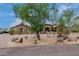 House with a large front yard, mature trees and circular driveway at 35140 N 52Nd Pl, Cave Creek, AZ 85331