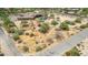 Aerial view of a property with a house, pool and a large empty lot at 35140 N 52Nd Pl, Cave Creek, AZ 85331