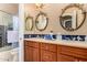 Elegant bathroom with double vanity, a shower, and decorative mirrors at 35140 N 52Nd Pl, Cave Creek, AZ 85331