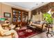 Cozy sitting area features a large bookcase, comfortable seating, and a rich-colored rug at 35140 N 52Nd Pl, Cave Creek, AZ 85331