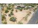 Aerial view showing a house, pool, stables and a large empty lot at 35140 N 52Nd Pl, Cave Creek, AZ 85331