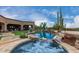 Inviting pool and spa surrounded by lush landscaping, creating a tranquil retreat at 35140 N 52Nd Pl, Cave Creek, AZ 85331