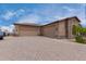 Three-car garage with paver driveway and stone accents at 35140 N 52Nd Pl, Cave Creek, AZ 85331