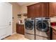 Bright laundry room, featuring modern washer and dryer, ample cabinetry, and a utility sink at 35140 N 52Nd Pl, Cave Creek, AZ 85331