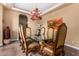 Formal dining room with a glass-top table and richly decorated chairs at 35140 N 52Nd Pl, Cave Creek, AZ 85331