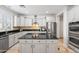 Modern kitchen with granite countertops, stainless steel appliances, and an island at 5116 W Trotter Trl, Phoenix, AZ 85083