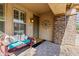 Quaint front porch with seating and welcoming decor at 5116 W Trotter Trl, Phoenix, AZ 85083