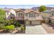 Two-story house with solar panels, landscaped yard, and a three-car garage at 5116 W Trotter Trl, Phoenix, AZ 85083