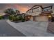 Two-story house with three-car garage at sunset at 5116 W Trotter Trl, Phoenix, AZ 85083