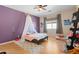 Bright bedroom with purple walls and plenty of space at 5116 W Trotter Trl, Phoenix, AZ 85083