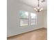 Dining room with wood-look tile floors, chandelier, and large windows at 19741 E Reins Rd, Queen Creek, AZ 85142