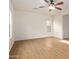 Spacious bedroom with wood-look tile floors, ceiling fan, and access to bathroom at 19741 E Reins Rd, Queen Creek, AZ 85142