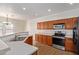 Modern kitchen with wood cabinets, stainless steel appliances, and double sink at 19741 E Reins Rd, Queen Creek, AZ 85142