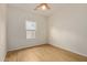 Bright bedroom with ceiling fan and wood flooring at 19741 E Reins Rd, Queen Creek, AZ 85142