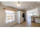 Bright kitchen boasts white cabinets, tile flooring, and a view into the adjacent living area at 17555 W Dalea Dr, Goodyear, AZ 85338