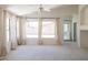 Sunlit living room with large windows and neutral carpeting at 17555 W Dalea Dr, Goodyear, AZ 85338
