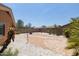 Landscaped backyard with a flagstone patio and fire pit at 17555 W Dalea Dr, Goodyear, AZ 85338