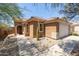 Tan house with a single-car garage and desert landscaping at 17555 W Dalea Dr, Goodyear, AZ 85338