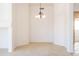 Bright dining area with a chandelier and neutral carpeting at 17555 W Dalea Dr, Goodyear, AZ 85338