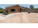 Backyard with flagstone patio, fire pit and gravel landscaping at 17555 W Dalea Dr, Goodyear, AZ 85338