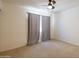 Bright bedroom with ceiling fan and large window at 17555 W Dalea Dr, Goodyear, AZ 85338