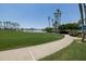 Green grassy area with walking path and lake views at 17555 W Dalea Dr, Goodyear, AZ 85338