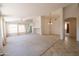 Bright and airy living room featuring neutral carpeting and large windows at 17555 W Dalea Dr, Goodyear, AZ 85338