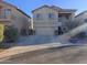 Two-story house with tan exterior, attached garage, and landscaping at 44973 W Sandhill Rd, Maricopa, AZ 85139