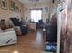 Home office features wood flooring, a large desk, and comfortable seating at 44973 W Sandhill Rd, Maricopa, AZ 85139