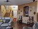 Open living room with gray couches and view of entryway staircase at 44973 W Sandhill Rd, Maricopa, AZ 85139