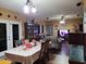 Open dining area with a large table, adjacent to the living room and kitchen at 44973 W Sandhill Rd, Maricopa, AZ 85139