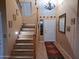 Elegant entryway with wood staircase, tile flooring, and decorative accents at 44973 W Sandhill Rd, Maricopa, AZ 85139