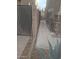 Neat side yard with a concrete pathway at 44973 W Sandhill Rd, Maricopa, AZ 85139