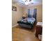Bright bedroom with wood flooring and a comfortable bed at 44973 W Sandhill Rd, Maricopa, AZ 85139