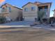 Two story house with tan exterior, attached garage, and landscaping at 44973 W Sandhill Rd, Maricopa, AZ 85139