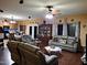 Bright living room with hardwood floors, comfortable seating, and views into the kitchen at 44973 W Sandhill Rd, Maricopa, AZ 85139
