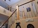 Open staircase with wood railing and decorative wall art at 44973 W Sandhill Rd, Maricopa, AZ 85139