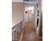 Upstairs hallway with wood flooring and access to bedrooms at 44973 W Sandhill Rd, Maricopa, AZ 85139