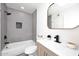Modern bathroom with gray tile, updated vanity, and bathtub at 916 S Melody Ln, Tempe, AZ 85281