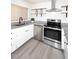 Updated kitchen with stainless steel appliances and granite countertops at 916 S Melody Ln, Tempe, AZ 85281